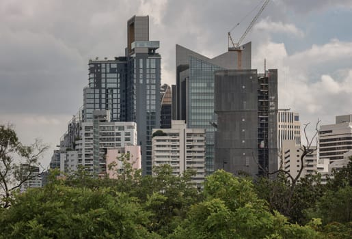 Bangkok, Thailand - 22 Jun, 2024 - Architecture exterior of Modern high-rise buildings on sky background. Picturesque view of skyscrapers and green spaces, Space for text, Selective focus.