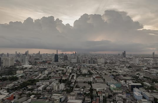Bangkok, Thailand - 28 May 2024 - Aerial view of skyscrapers and dramatic sky before sunset. Beautiful clouds in the sky over large metropolitan city of bangkok, Space for text, Selective focus.