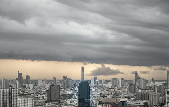 Bangkok, Thailand - 20 Jun, 2024 - Aerial view of skyscrapers and dramatic sky before sunset. Beautiful clouds in the sky over large metropolitan city of bangkok, Space for text, Selective focus.