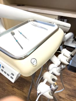 Denver, Colorado, USA-July 12, 2024-Close-up view of a tray with dental tools in a modern dental office, showcasing the organized setup and clean environment for dental procedures.
