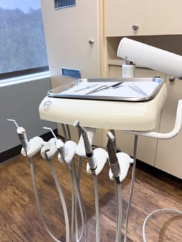 Denver, Colorado, USA-July 12, 2024-Close-up view of a tray with dental tools in a modern dental office, showcasing the organized setup and clean environment for dental procedures.