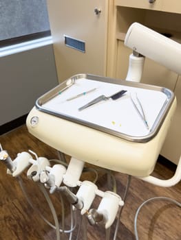 Denver, Colorado, USA-July 12, 2024-Close-up view of a tray with dental tools in a modern dental office, showcasing the organized setup and clean environment for dental procedures.