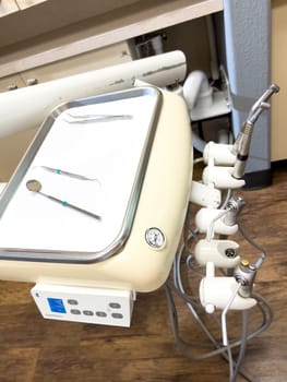 Denver, Colorado, USA-July 12, 2024-Close-up view of a tray with dental tools in a modern dental office, showcasing the organized setup and clean environment for dental procedures.