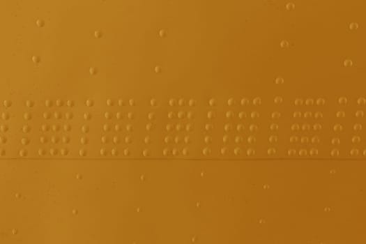 Orange Surface of a metal wall with rivets close-up.