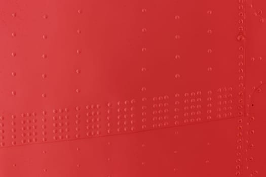 Protection of military equipment made of sheet metal with red rivets.