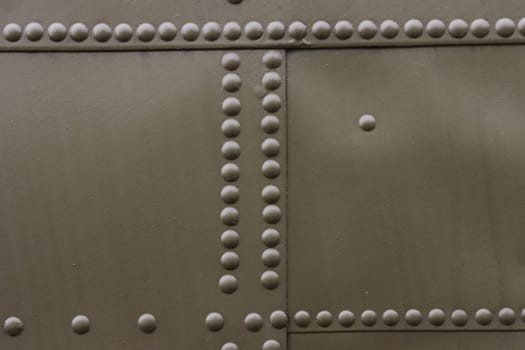 Riveted painted metal background texture.