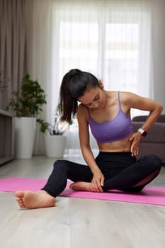 Sad sporty woman feeling hurt in her side after home training, Woman feeling pain