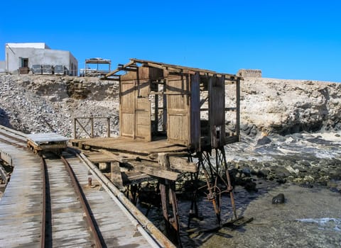 Big Brother Island, Egypt - October 26, 2005:  antique iron and wooden pier in front of the lighthouse on Big Brother Island, Red Sea, Egypt