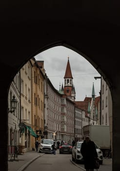 Munich, Germany - Dec 21, 2023 - The Old Town building (Altes Rathaus) Hall and Old buildings on the east side of Marienplatz in the city centre of Munich. View from under the bridge, Space for text, Selective focus.