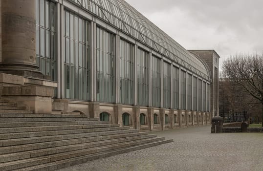 Munich, Germany - Dec 22, 2023 - Perspective view of Bayerische Staatskanzlei is a government building with glass, Column and stone stairs. Bavarian State Chancellery building (the former Bayerische Armeemuseum, Bavarian Army museum), Space for text, Selective focus.