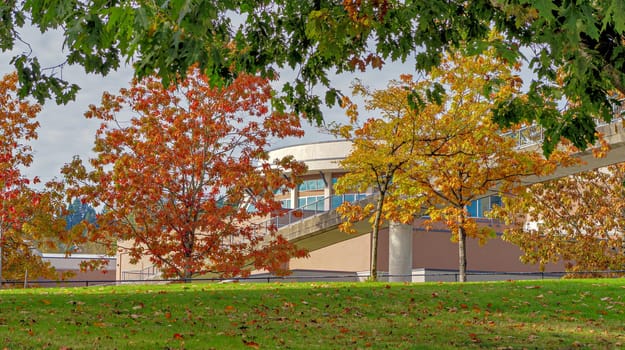 Round office building with crosswalk bridge on autumn season in Vancouver, Canada.