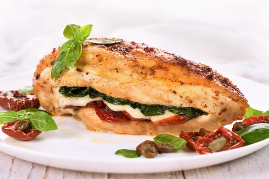 Baked chicken breast with spinach, sun-dried tomatoes and mozzarella