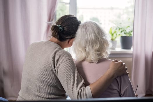 Aged mom encourage beloved adult girl child in difficult life situation.