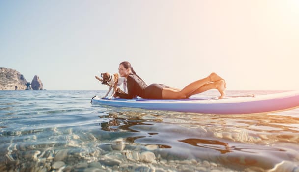 Sea woman sup. A happy positive woman in hat with family relaxing in sea, aerial back view of family on SUP board floating on calm water. Active lifestyle at sea. Summer vacation. Slow motion