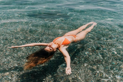 Weight loss and body image concept. Woman with perfect fit body walking confident on beach. Unrecognizable sexy young woman.