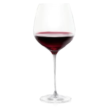 Spiegelau Vino Grande Bordeaux glass thin crystal stemware oversized bowl gentle swirl of deep crimson. Close-up wine glass, isolated on transparent background