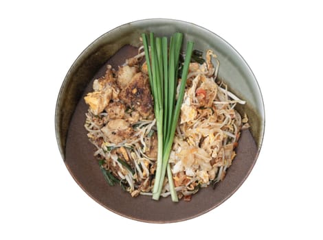 Traditional Fried Thai Noodle (pad thai) and Stirred fried turnip cake or Fried radish cake (chai tow kway) on Ceramic plate isolated on white background with clipping path. Top view, Selective focus.
