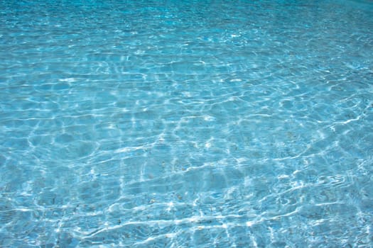 Clear blue water with ripples, presenting a tranquil and peaceful aquatic scene.