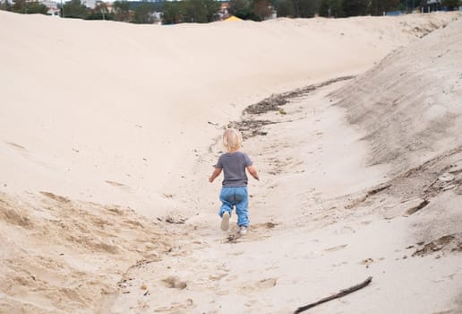 a cute girl walking on the sand beach