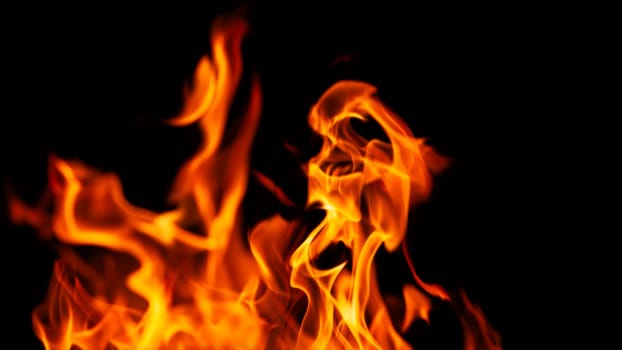 Decorative background with fire flames on black with copy space