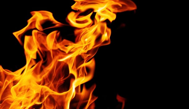 Decorative background with fire flames on black with copy space