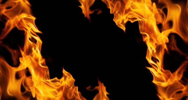 Decorative background with fire flames on black with copy space