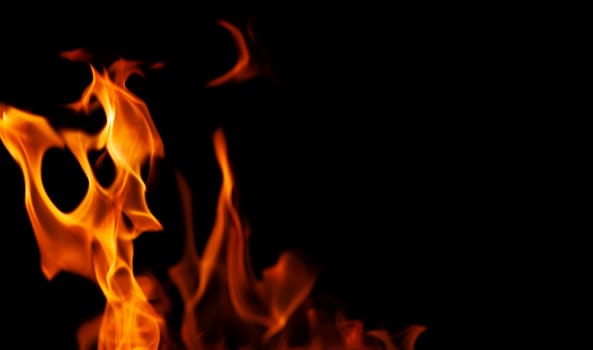 Decorative background with fire flames on black with copy space