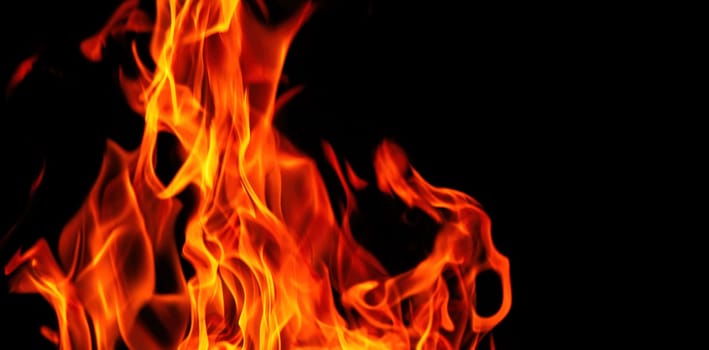 Decorative background with fire flames on black with copy space