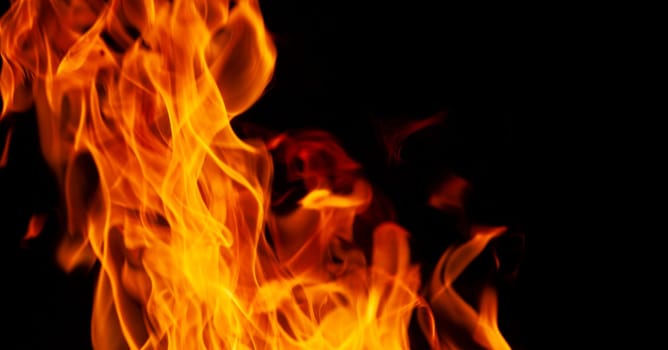 Decorative background with fire flames on black with copy space