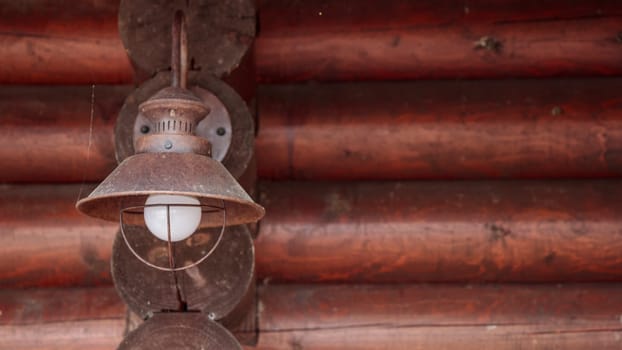 The old kerosene lamp on a wooden floor, old gray cement backdrop, banner with copyspace