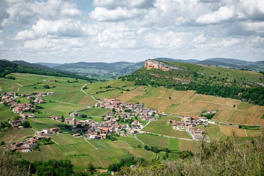 Environment of La Roche de Solutre with vineyards, and the giant rock to climb on the background, Burgundy, France