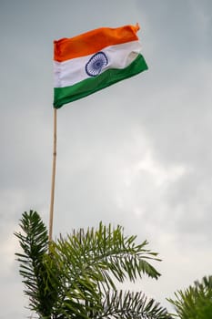 Indian tricolor flag against storm cloudy sky showing national pride and celebration of independence and republic day and the tough times for India ahead
