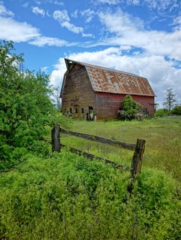 A landscape photo of an old abandoned barn under a dramatic cloudy sky in north Idaho.
