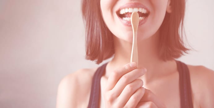 A young girl flosses her teeth, a woman takes good care of her snow-white smile, the health of her gums and tooth enamel.