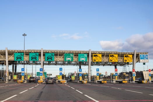 The car pays the cashier for the entrance to the motorway toll gate.