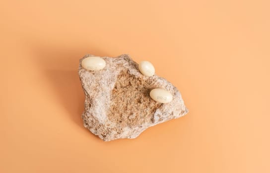 Progesterone Capsules On Stone, Peach Yellow Background. Natural Product Concept. Menopausal Hormone Therapy, Oral Route. Menopause. Cycle Changes. Top View. Hormones. High Quality Photo