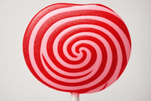 A pink and red swirled lollipop with a classic candy design, perfect for a sweet indulgence.