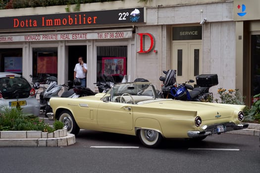 Monte Carlo, Monaco - June 14, 2023: Beige vintage Ford Thunderbird aka T-Bird, a personal luxury car manufactured and marketed by Ford Motor Company circa 1957 parked on the street