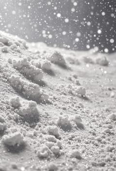 The image depicts a close-up view of a snow-covered landscape. The foreground is dominated by a thick layer of fresh, pristine snow, while the background features a soft, gray sky with falling snowflakes. The scene evokes a sense of peace and tranquility, reminiscent of a winter wonderland.