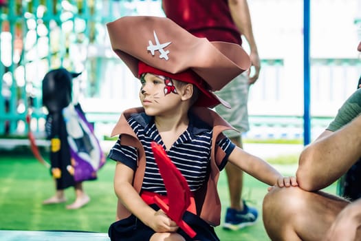 Boy Cat Pirate costume. Halloween party in kindergarten. Aqua makeup painted kids face. Bright festive.