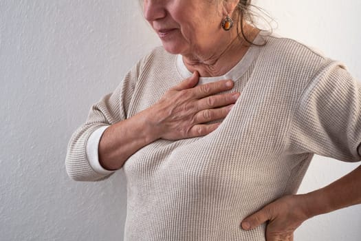 Woman having a pain in the heart area. Heart Attack. Painful Chest.