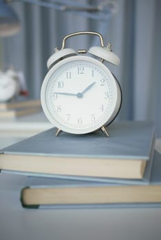 black to school concept with apple and clock on books on table..