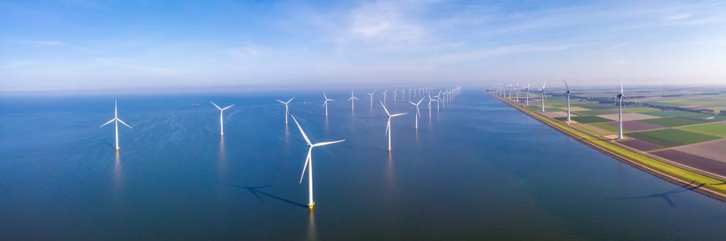 aerial view of windmill turbines in the ocean at the Netherlands, green energy concept windmill turbines
