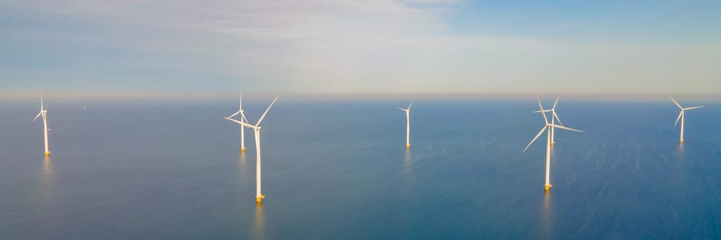 Wind turbine. Aerial view of wind turbines or windmills farm field in blue sea
