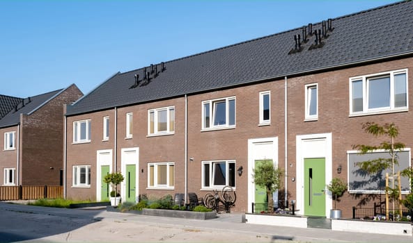 Dutch Suburban area with modern family houses, newly build modern family homes in the Netherlands, dutch family house in the Netherlands, Street with modern family houses in urban suburb