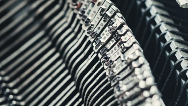 Letters and numbers on typo keys of an old manual typewriter on a retro writing machine, close up view