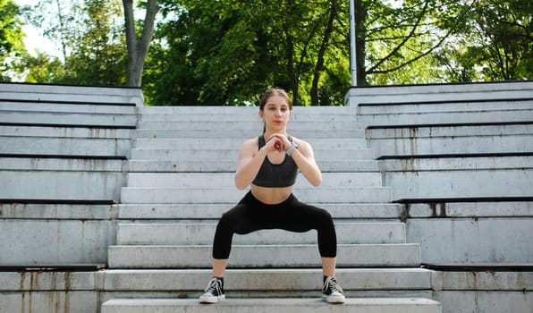 Young Girl Performing Squats Outdoors For Fitness And Bodybuilding, Focusing On Legs