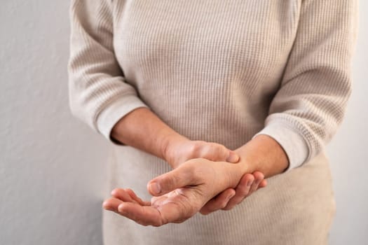 Female old hand measure check arm pulse. Elderly woman heart health.