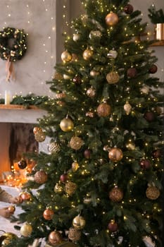The interior of the Scandinavian-style living room, decorated for the Christmas holidays. Christmas tree next to the fireplace