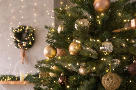 The interior of the Scandinavian-style living room, decorated for the Christmas holidays. Christmas tree next to the fireplace
